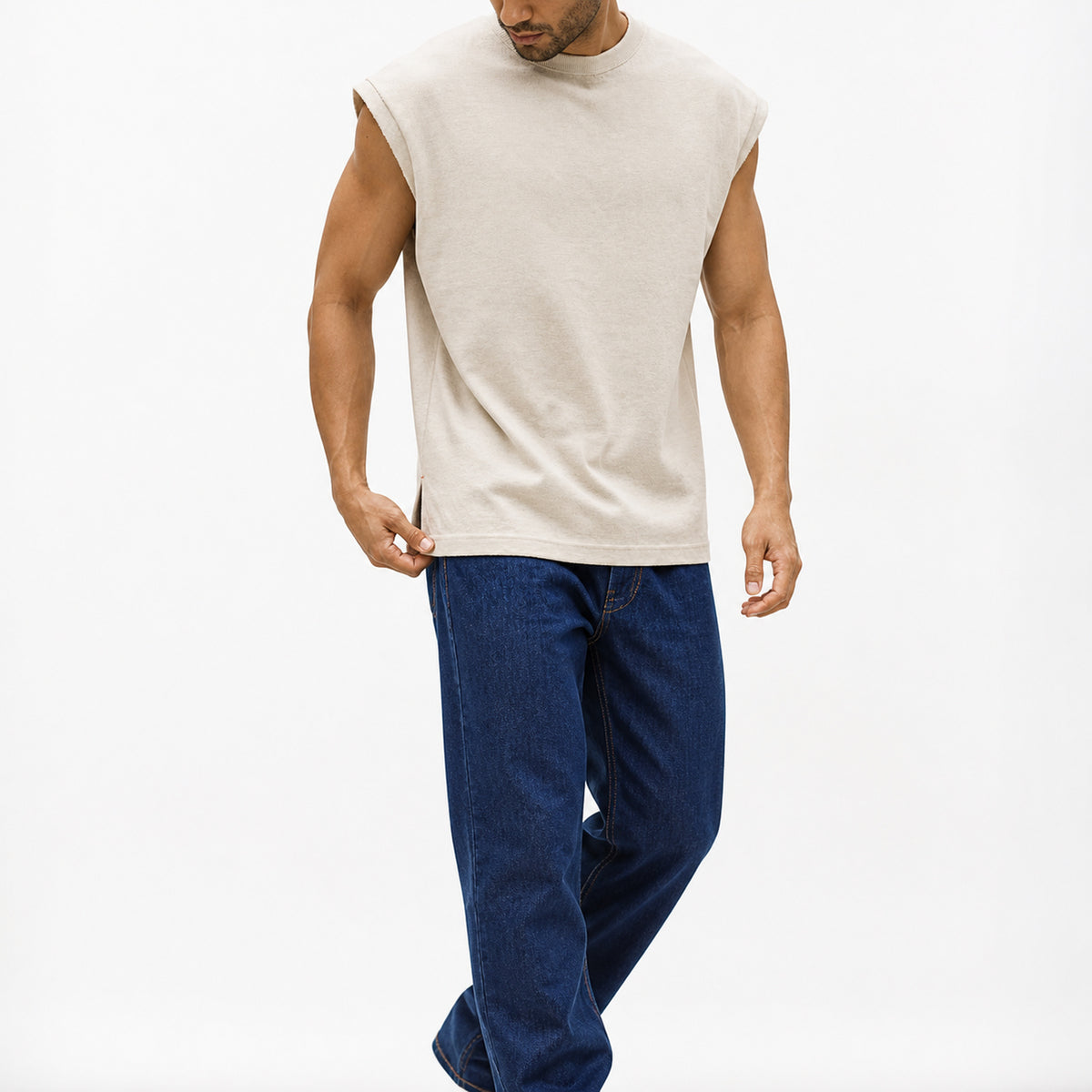 Man wearing the beige knit shoulder vest with navy trousers, full view